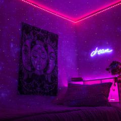 Nebula projected across a bedroom wall and ceiling